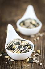 Portion of mixed Seeds (close-up shot, selective focus) on wooden background