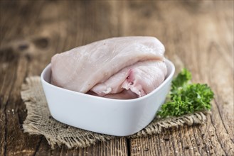 Wooden table with chicken cutlet (detailed close-up shot)