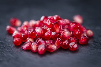 Pomegranate on a vintage background as detailed close-up shot (selective focus)