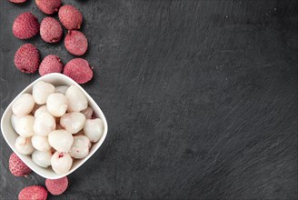 Portion of Litchis as detailed close up shot on a slate slab (selective focus)