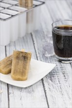 Fresh made Cola Popsicles on wooden background (selective focus, close-up shot)