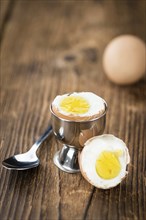 Wooden table with boiled Eggs (selective focus, close-up shot)