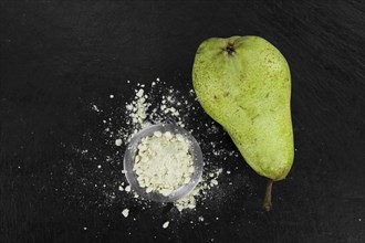 Portion of fresh made Pear powder on a slate slab (selective focus)