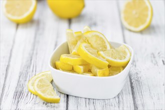 Fresh made Lemon (sliced) on a vintage background (close-up shot)