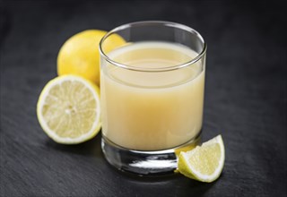 Some Juice (lemon) on a slate slab (close-up shot, selective focus)