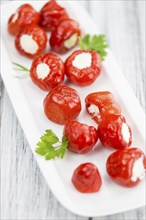 Homemade Filled Pimientos on vintage background (selective focus, close-up shot)