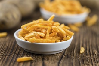 Portion of fried potato sticks (close-up shot, selective focus)