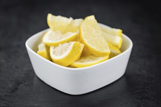 Fresh made Lemon (sliced) on a vintage background (close-up shot)