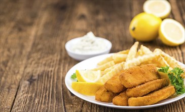 Fried Fish Fingers (selective focus) on wooden background (selective focus)