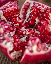 Pomegranate on a vintage background as detailed close-up shot (selective focus)