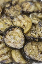 Fresh made Zucchinis (grilled) on an old and rustic wooden table (selective focus, close-up shot)