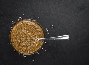 Fresh made German Cuisine (sweet Mustard) on a vintage background (close-up shot)