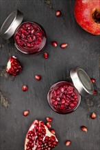 Healthy preserved Pomegranate seeds on a vintage slate slab (close-up shot, selective focus)