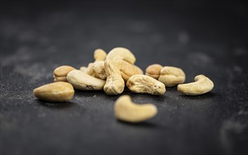 Some roasted Cashew Nuts as detailed close up shot (selective focus)