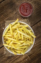 Portion of fresh made French Fries (close-up shot, selective focus)