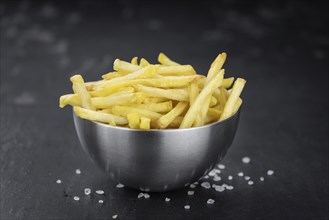 Portion of fresh made crispy French Fries (selective focus, close-up shot)