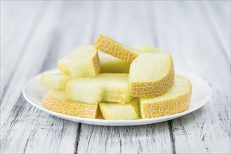 Honeydew Melon on a vintage background as detailed close-up shot (selective focus)