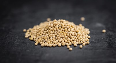 Portion of Seeds (Mustard) on a rustic slate slab (selective focus, close-up shot)