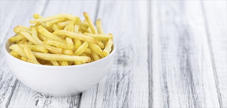 Portion of fresh made crispy French Fries (selective focus, close-up shot)