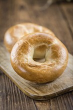 Fresh baked Bagels on a wooden table (selective focus, close-up shot)