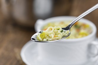 Portion of fresh made Alphabet Soup (selective focus, close-up shot)