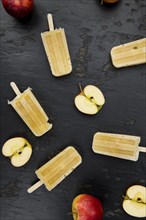 Fresh made Apple Popsicles (selective focus, close-up shot) on a vintage background