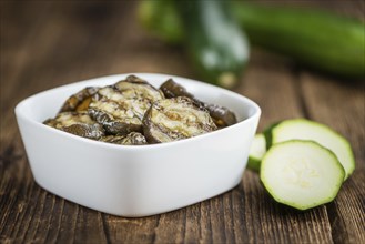 Homemade Antipasti (Grilled Zucchinis) on vintage background (selective focus, close-up shot)