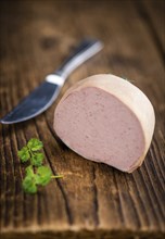 German Leberwurst on an old wooden table as detailed close-up shot (selective focus)