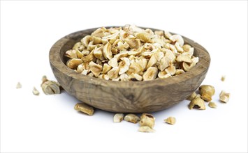 Freshly chopped Hazelnuts as detailed close up shot isolated on white background (selective focus)