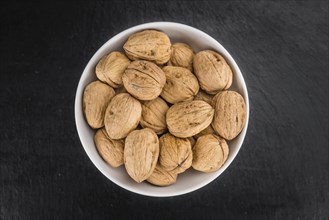 Walnuts on a vintage background as detailed close-up shot (selective focus)