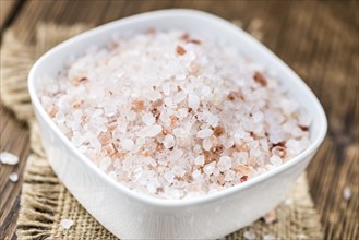 Pink Salt on a vintage background as detailed close-up shot (selective focus)