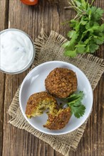 Homemade Falafel (close-up shot, selective focus) on wooden background