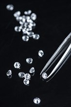 Small Diamonds on dark background as close up shot (selective focus)