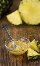 Fresh made Pineapple Jam on an old and rustic wooden table, selective focus, close-up shot