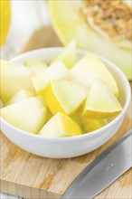 Honeydew Melon on rustic wooden background (close-up shot)