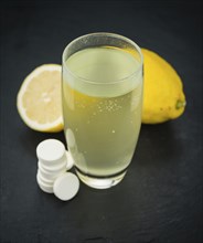 Some Vitamin C Tablets on a slate slab as detailed close-up shot, selective focus