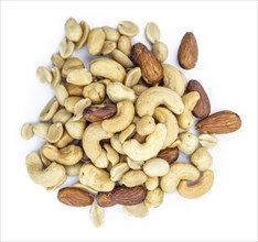 Portion of roasted nuts isolated on white background as close up shot (selective focus)