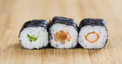 Portion of Sushi on a wooden table (selective focus, close-up shot)