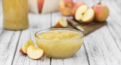 Portion of homemade Applesauce (selective focus, close-up shot) on vintage background