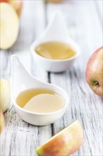 Portion of fresh made Applesauce (close-up shot) on vintage background