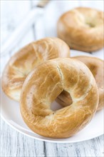 Fresh baked Bagels (selective focus) on an old wooden table