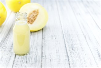 Homemade Honeydew Melon Smoothie on wooden background (selective focus)