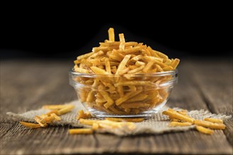 Potato Sticks (close-up shot, selective focus) on an old wooden table