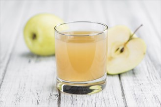 Apple Juice on a vintage background as detailed close-up shot (selective focus)