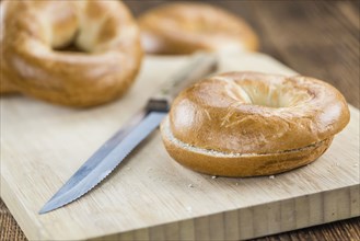 Fresh made plain Bagel (selective focus) on vintage background (close-up shot)