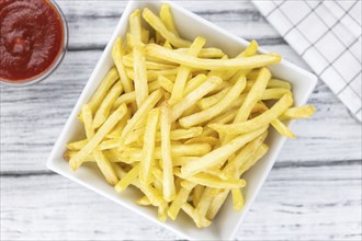 Portion of fresh made French Fries (close-up shot, selective focus)