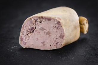 Portion of German Leberwurst as detailed close up shot on a slate slab (selective focus)