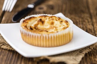 Fresh made Mini Cheesecake on an old and rustic wooden table (selective focus, close-up shot)