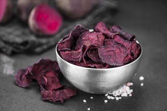 Beetroot Chips on a vintage looking slate slab (selective focus)