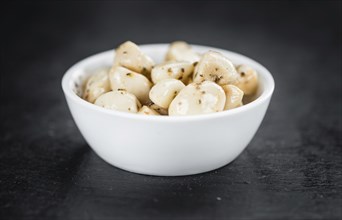 Portion of fresh Preserved Garlic (close-up shot, selective focus)